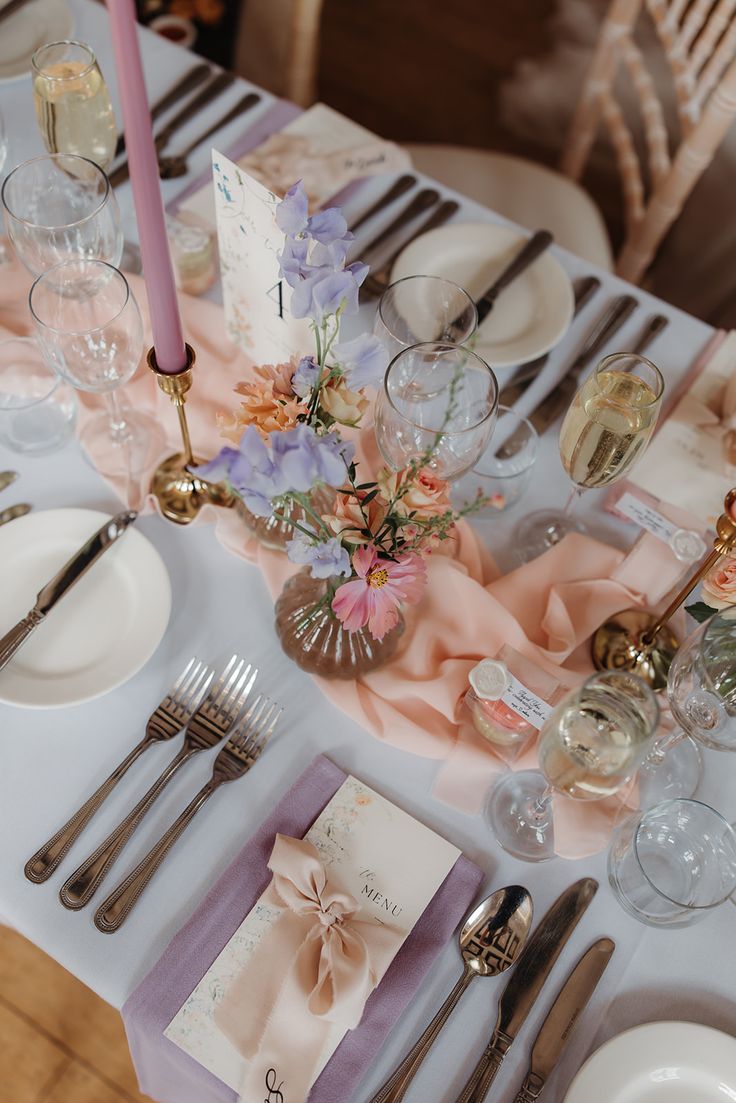 The photo shows an aerial shot of a wedding table set up with pastel colours and flowers.