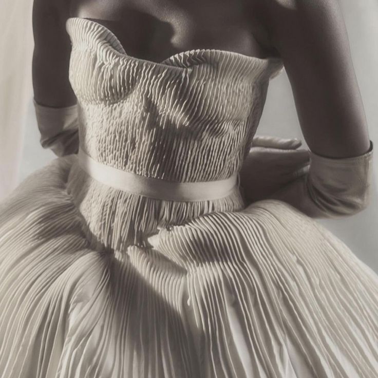The photo shows a close up of a lady in a bubble hem wedding dress.